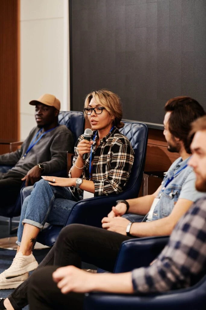 woman on stage in a panel discussion. How to become a panelist